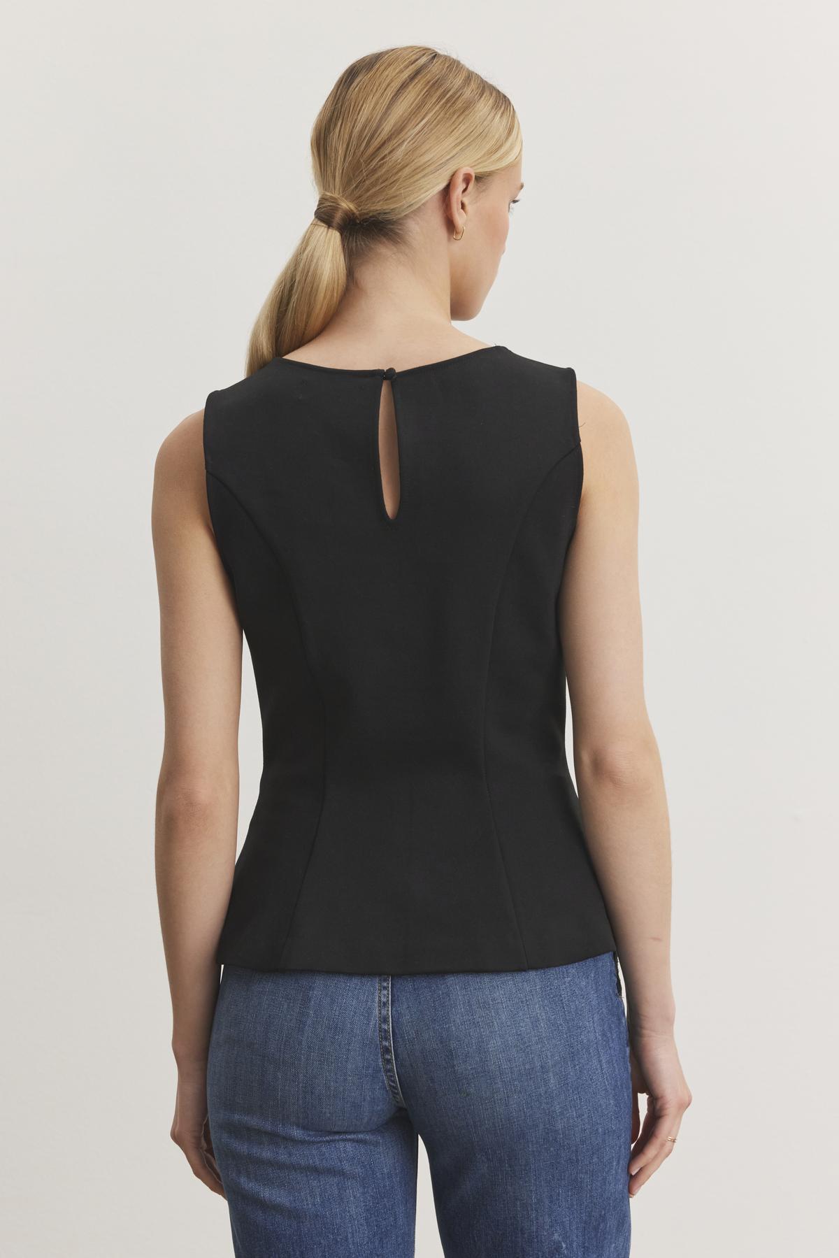 A person is seen from the back wearing the FELICITEE PONTE TOP by Velvet by Graham & Spencer, paired with blue jeans.