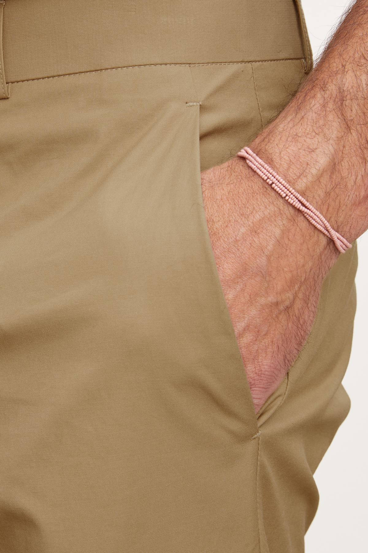 A man wearing Velvet by Graham & Spencer STING POPLIN PANT and a pink bracelet.-36009121677505