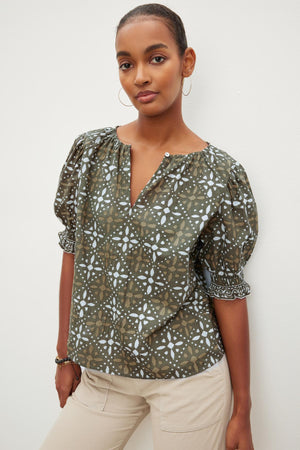 The model is wearing a Velvet by Graham & Spencer ALEX PRINTED BLOUSE.