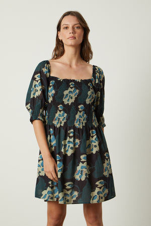 a woman wearing a black and blue Velvet by Graham & Spencer RAMIRA PRINTED DRESS.