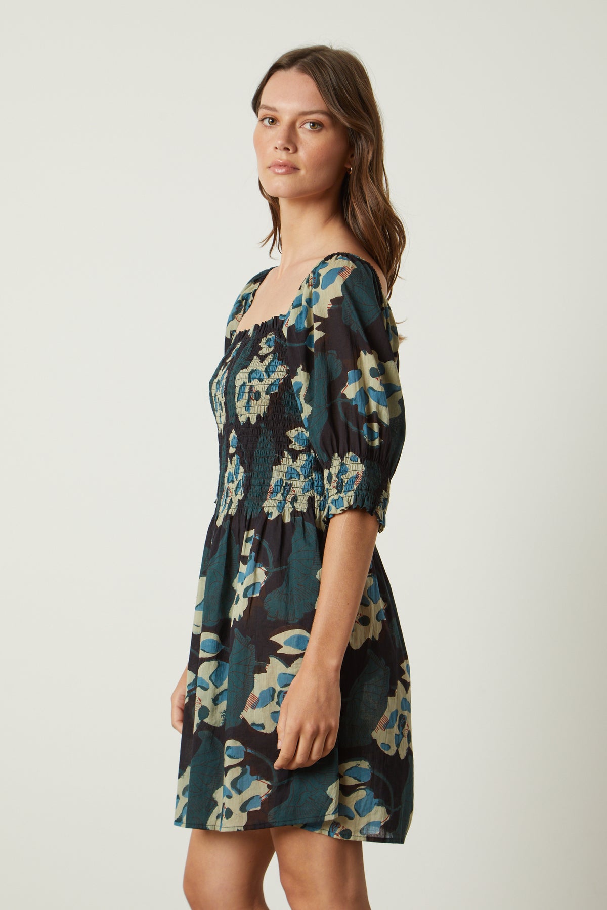 A woman wearing a Velvet by Graham & Spencer RAMIRA PRINTED DRESS.