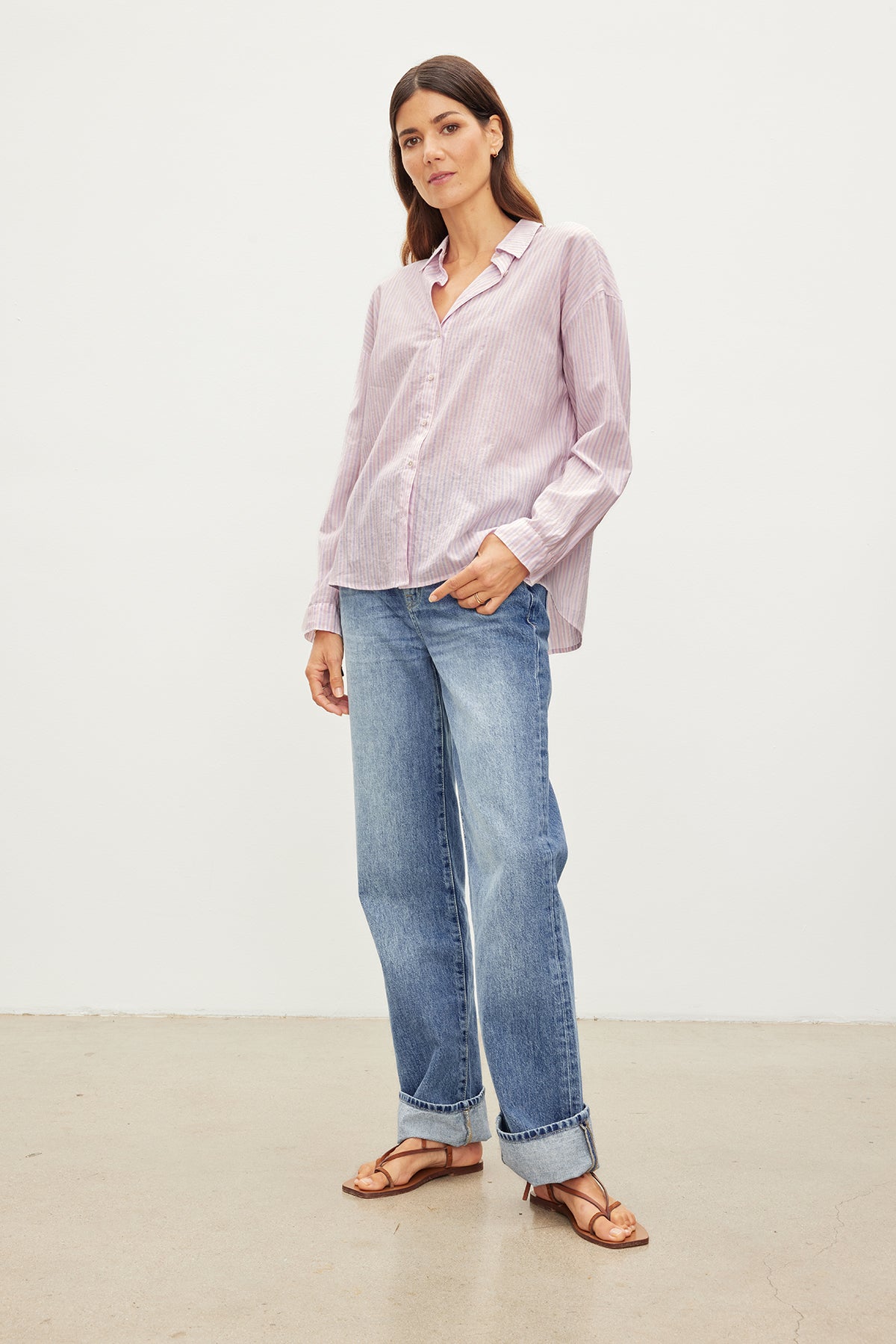 The model is wearing an ASHLYN STRIPED BUTTON-UP SHIRT by Velvet by Graham & Spencer, a wardrobe staple in contemporary style.-35955417874625