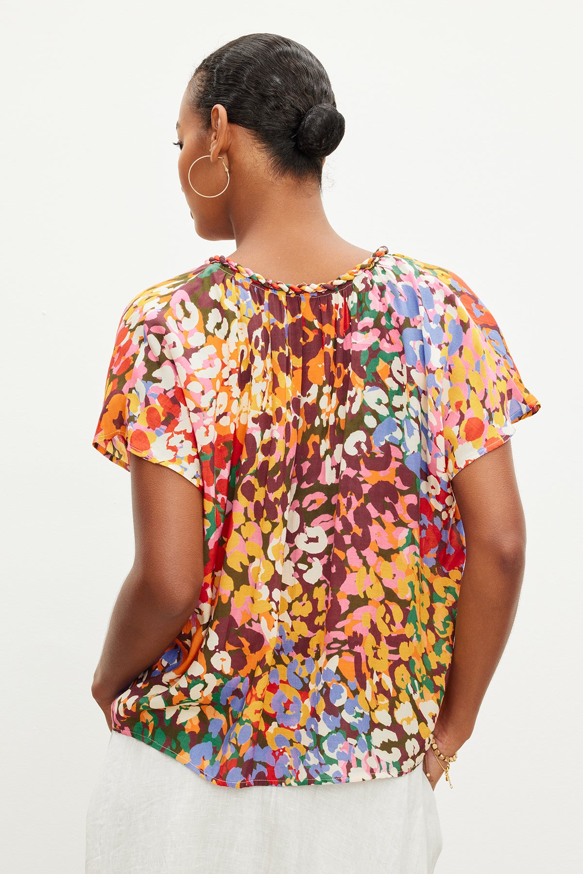 The back view of a woman wearing a Velvet by Graham & Spencer Trixy Printed Cocoon Top.-35967708299457