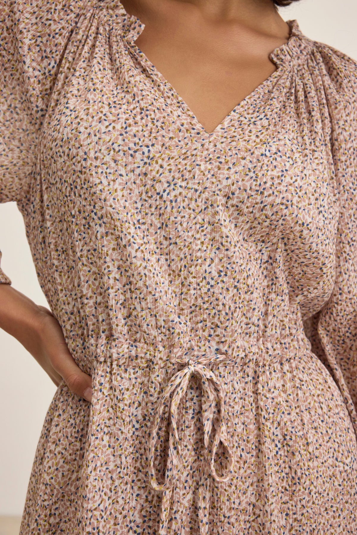 Close-up of someone wearing the LIMA PRINTED CRINKLE COTTON GAUZE DRESS by Velvet by Graham & Spencer, featuring a patterned design, lightweight fabric, gathered waist, and tie detail.-38820676305089