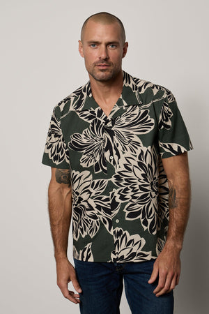 Iggy Button-Up Shirt in Catalina print with large bold black and cream abstract flower print on dark green background, with dark blue denim front