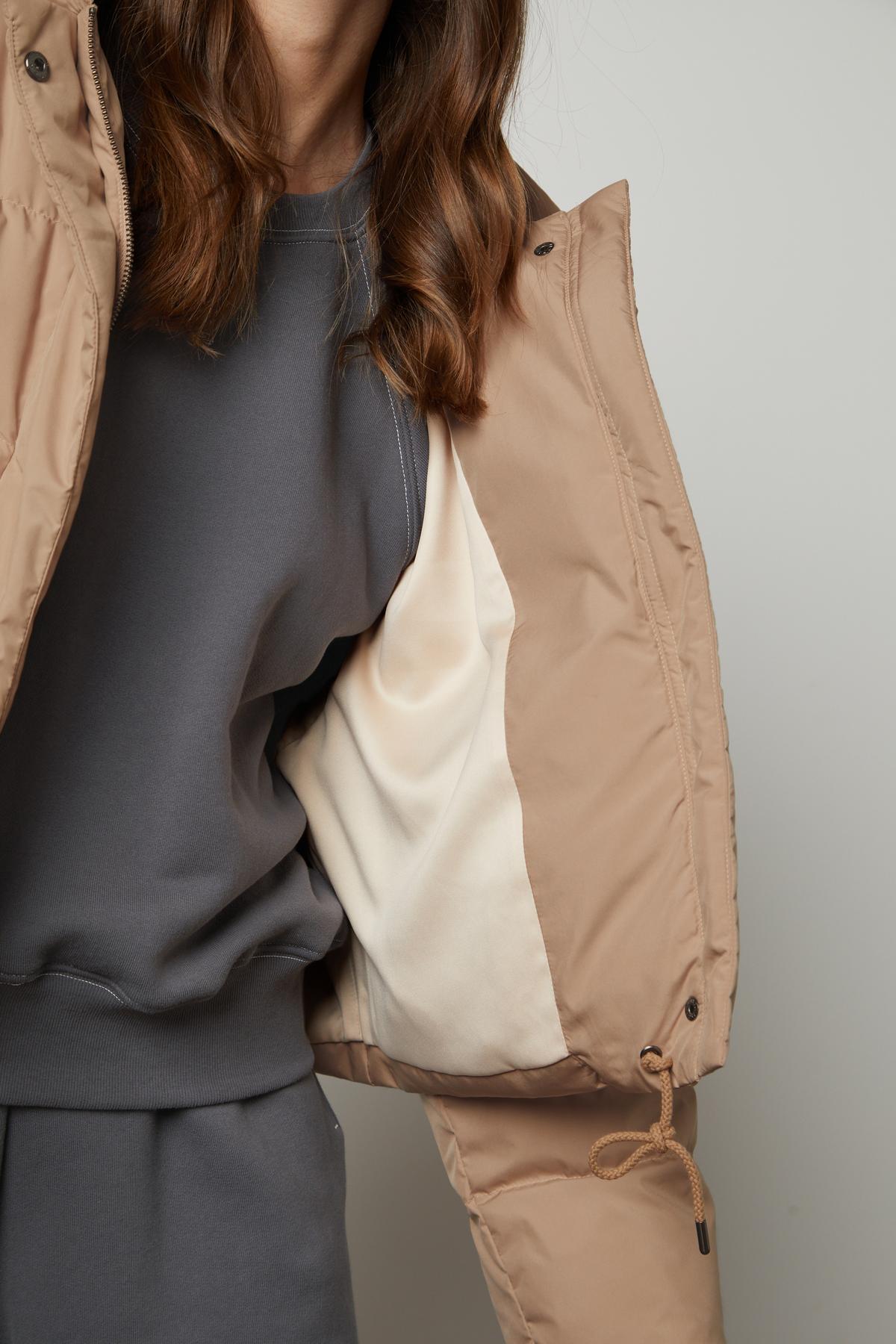 A woman wearing a Velvet by Graham & Spencer RAYLIN CROPPED PUFFER JACKET.-26910089838785