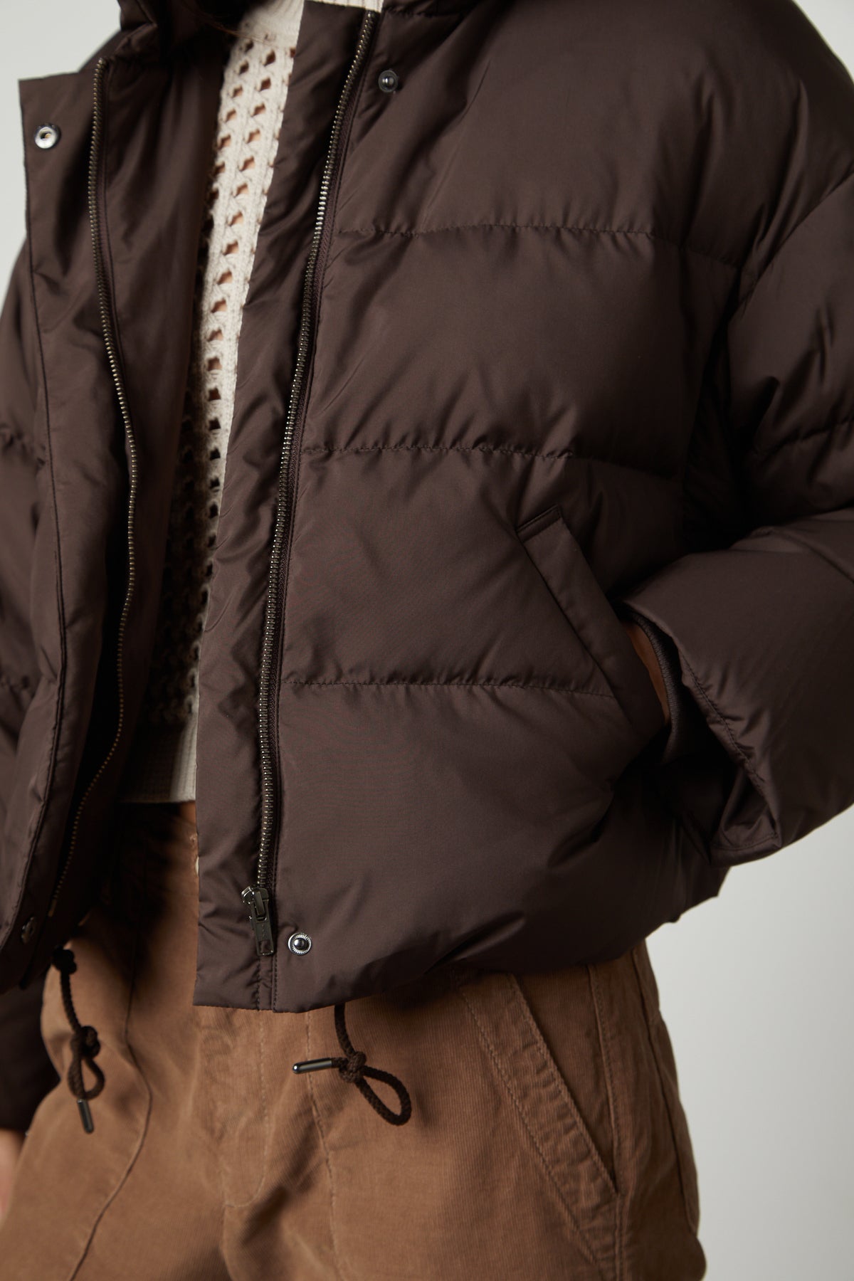 The model is wearing a cool Velvet by Graham & Spencer RAYLIN CROPPED PUFFER JACKET.