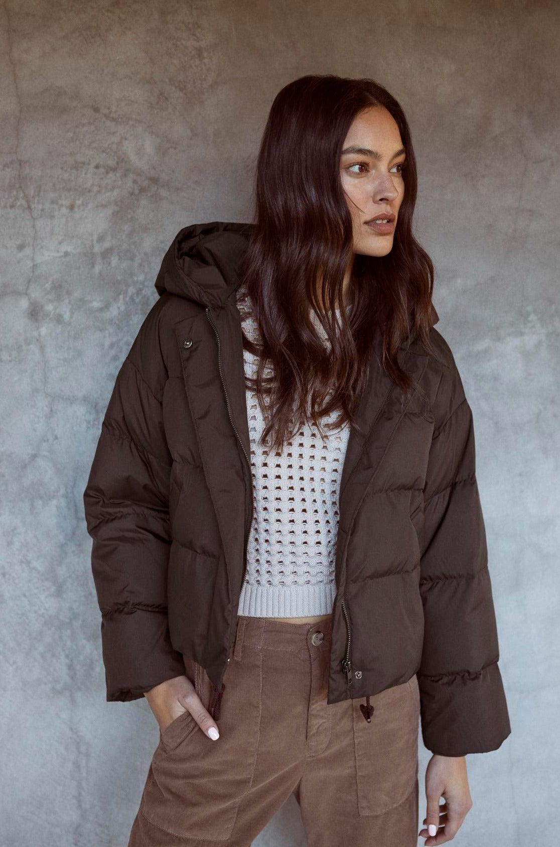 A cool woman in a Velvet by Graham & Spencer RAYLIN CROPPED PUFFER JACKET.