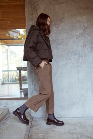 A woman wearing a cool black Velvet by Graham & Spencer RAYLIN CROPPED PUFFER JACKET.