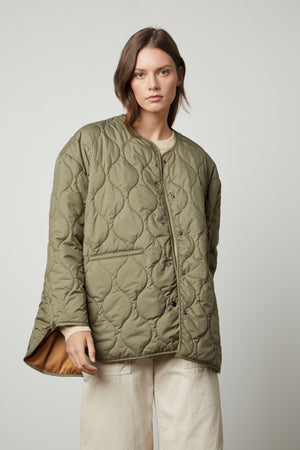 A woman wearing a Velvet by Graham & Spencer PAITYN QUILTED JACKET.