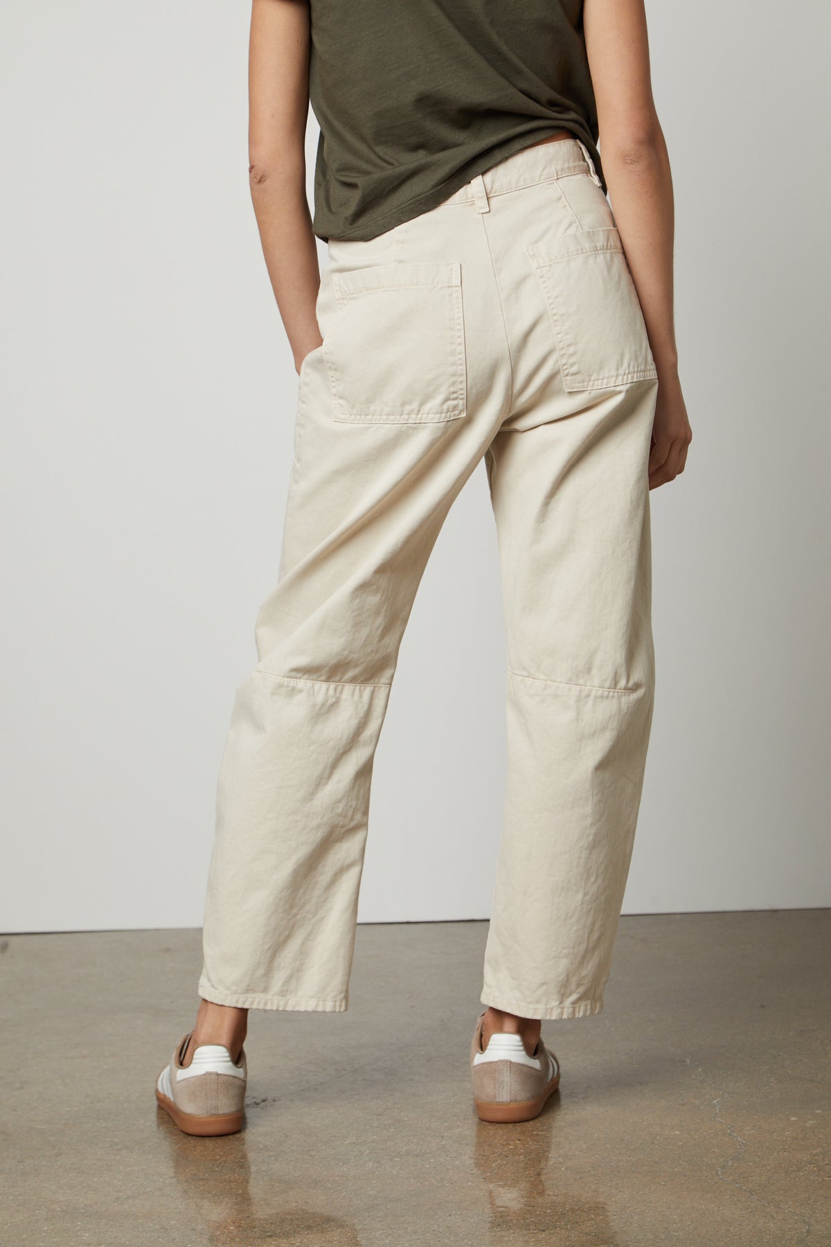 The back view of a woman wearing Velvet by Graham & Spencer BRYLIE SANDED TWILL UTILITY PANT with patch pockets.-36118557032641