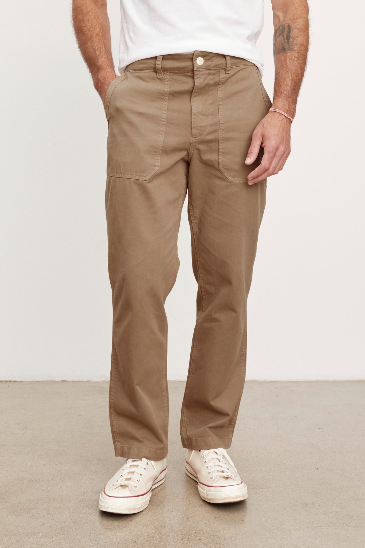   A man wearing Velvet by Graham & Spencer TOBY SANDED TWILL PANT and white sneakers. 