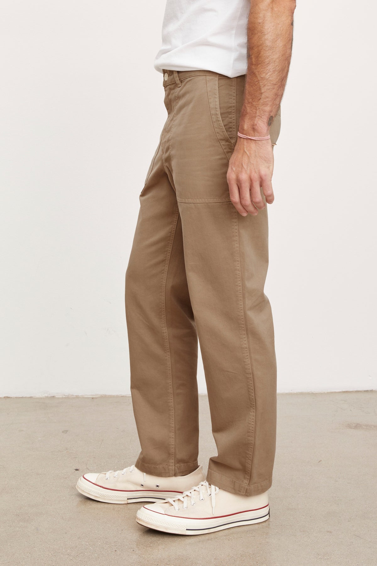 A man wearing Velvet by Graham & Spencer's TOBY SANDED TWILL PANT and white sneakers.-36009011085505