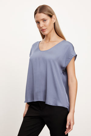 The model is wearing a KALI SATIN SCOOP NECK TOP by Velvet by Graham & Spencer with v-neck and satin pants.