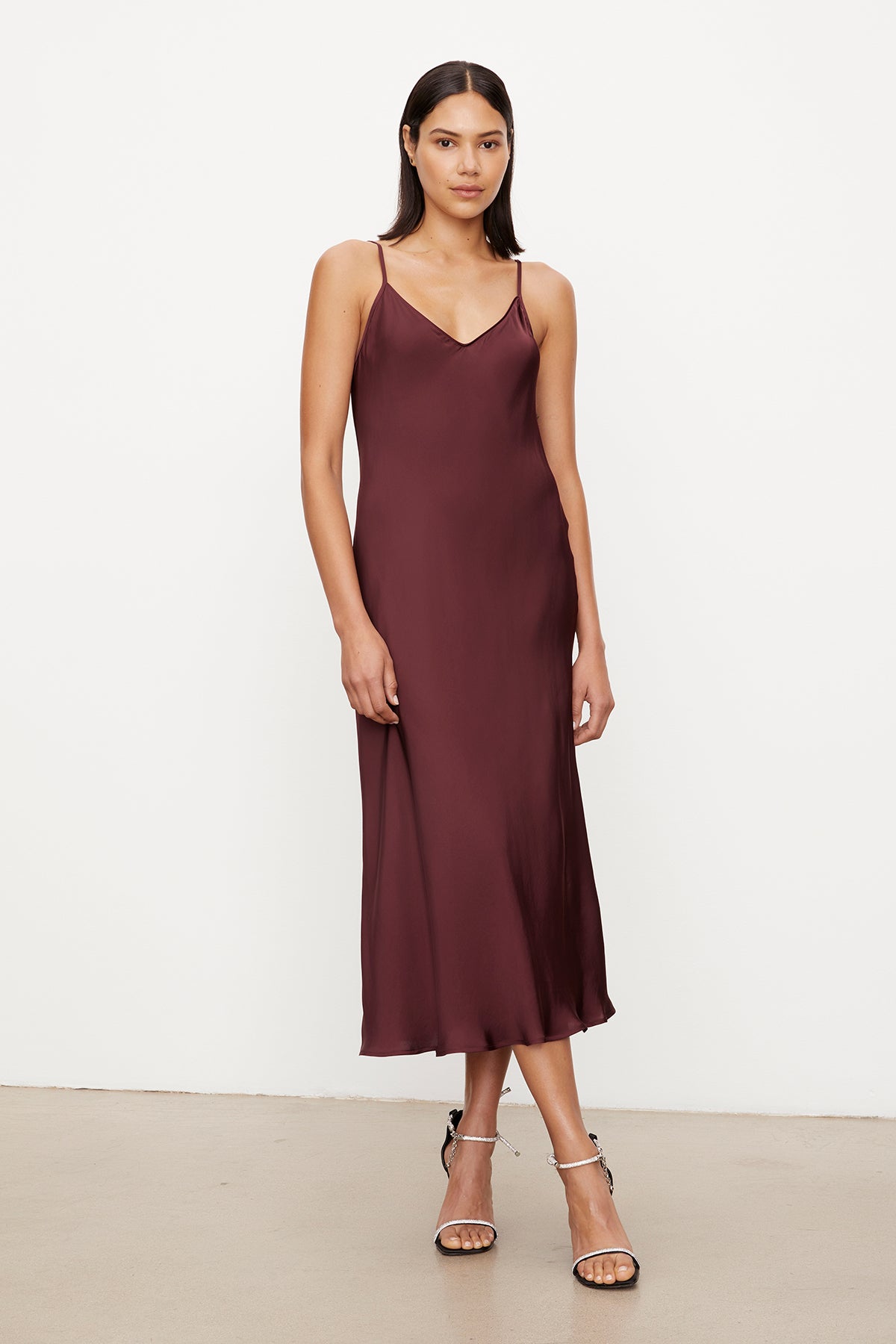 A versatile model wearing a Velvet by Graham & Spencer POPPY SATIN SLIP DRESS with adjustable straps.