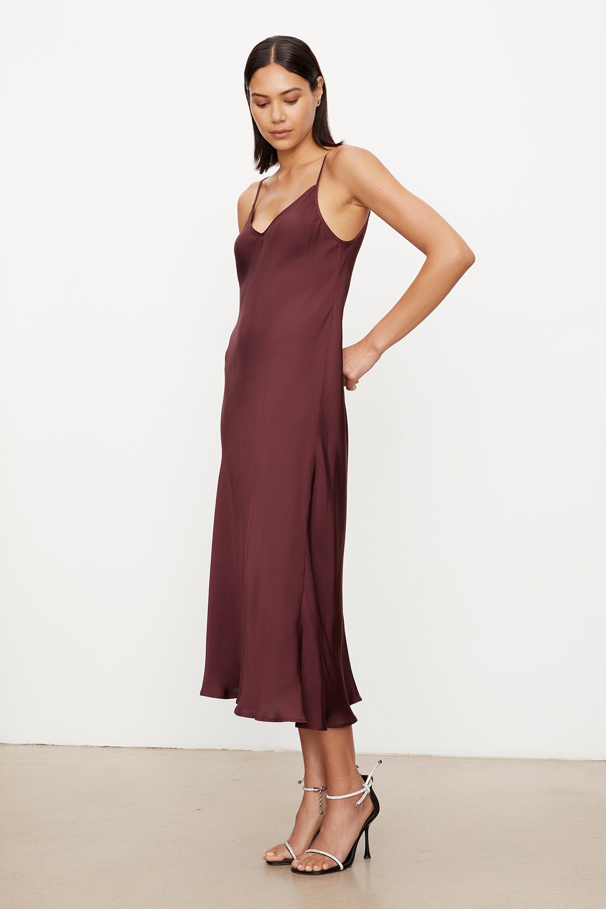 The model is wearing a Velvet by Graham & Spencer POPPY SATIN SLIP DRESS with adjustable straps.