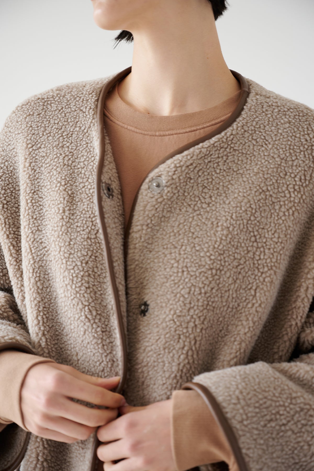 A woman wearing a beige Velvet by Jenny Graham GREENWICH COAT with patch pockets.-35547844837569