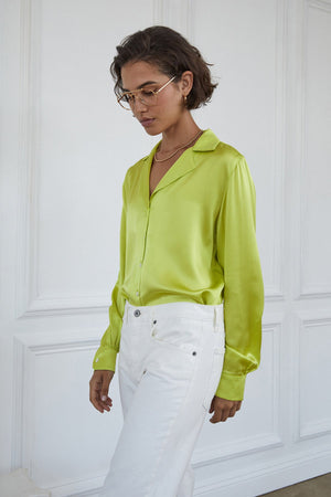 Soho Top in lime tucked into white denim model wearing gold neckace and glasses