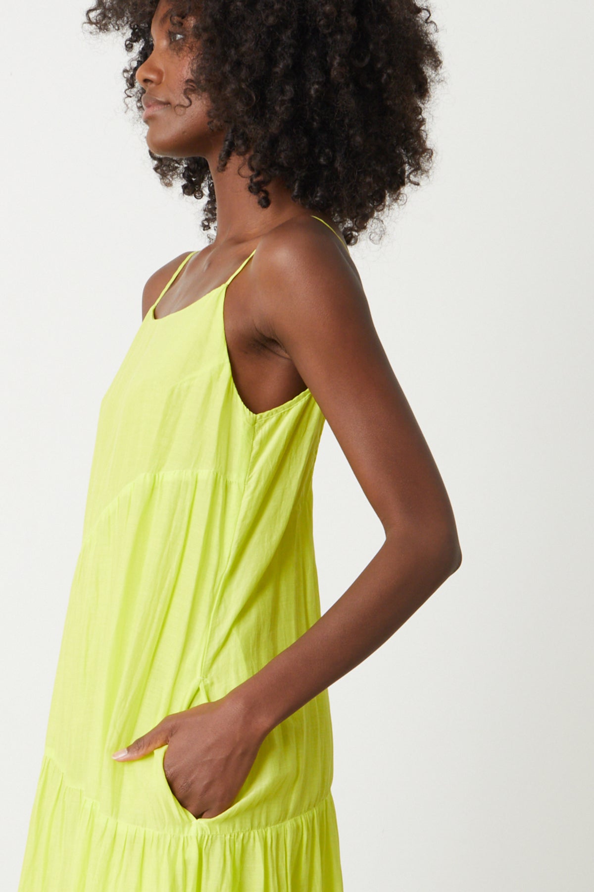 The model is wearing the Velvet by Graham & Spencer BILLIE TIERED MAXI DRESS with ruffles.