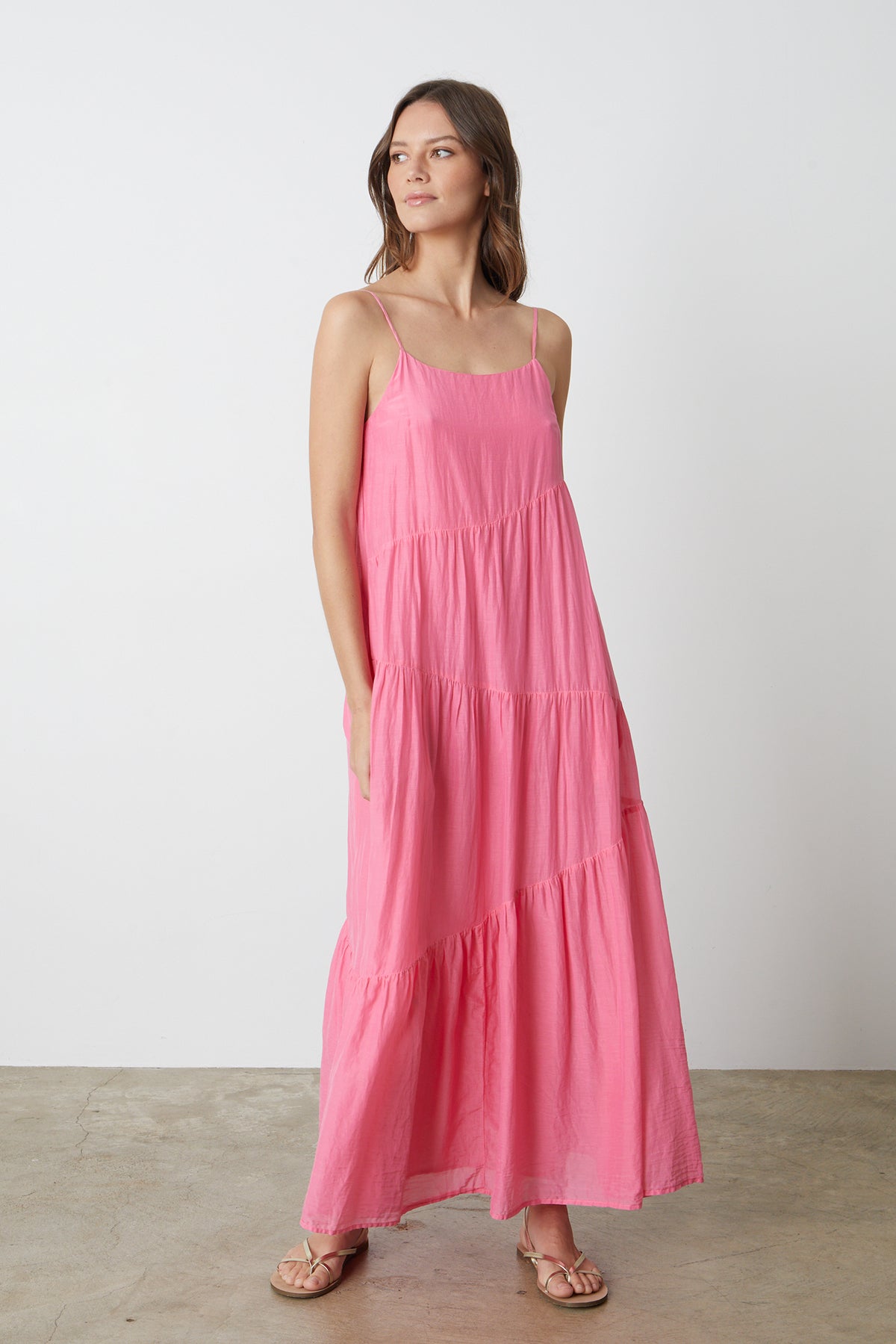 a woman wearing a Velvet by Graham & Spencer BILLIE TIERED MAXI DRESS and sandals.