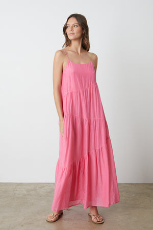 a woman wearing a Velvet by Graham & Spencer BILLIE TIERED MAXI DRESS and sandals.