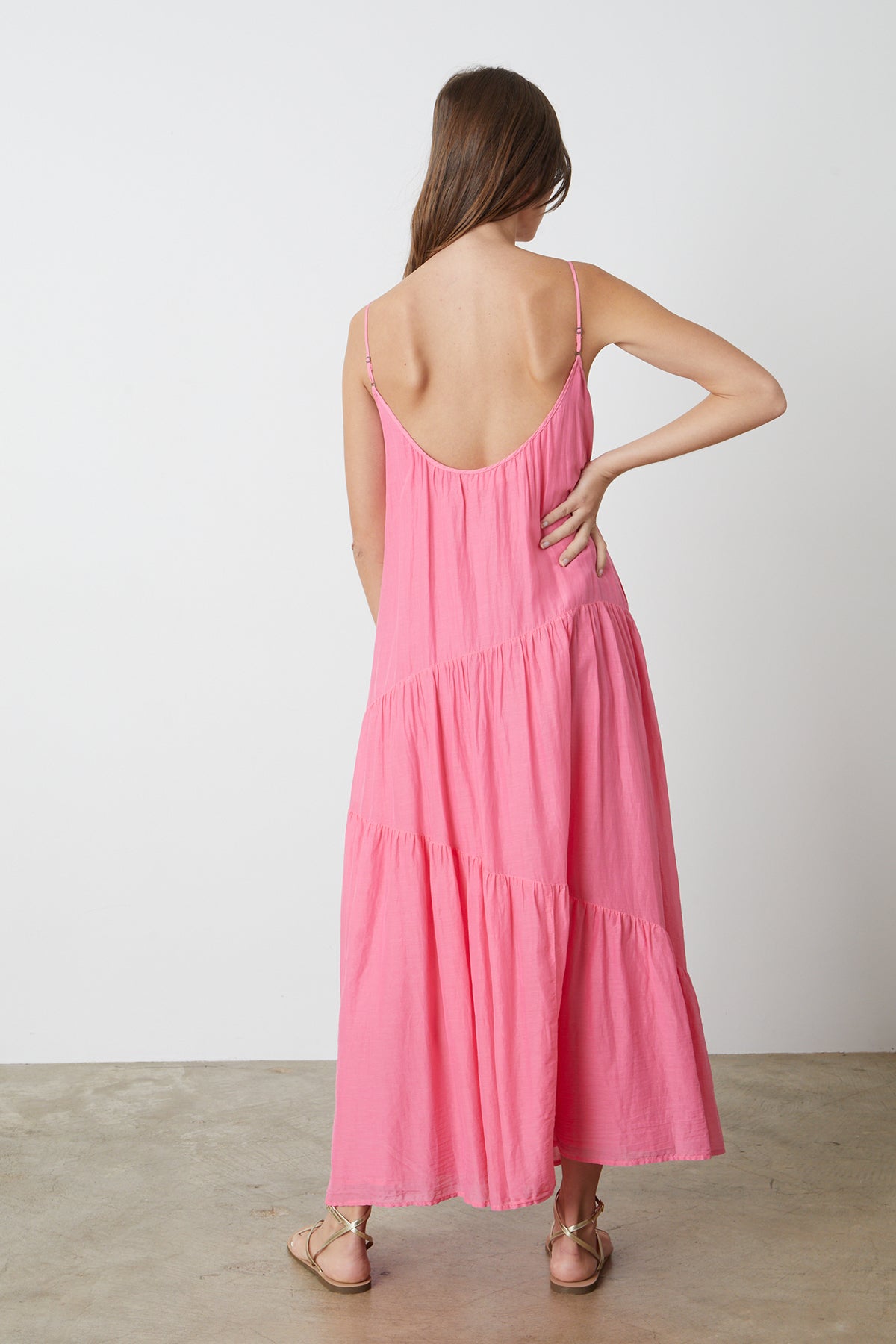 The back view of a woman wearing a Velvet by Graham & Spencer BILLIE TIERED MAXI DRESS.