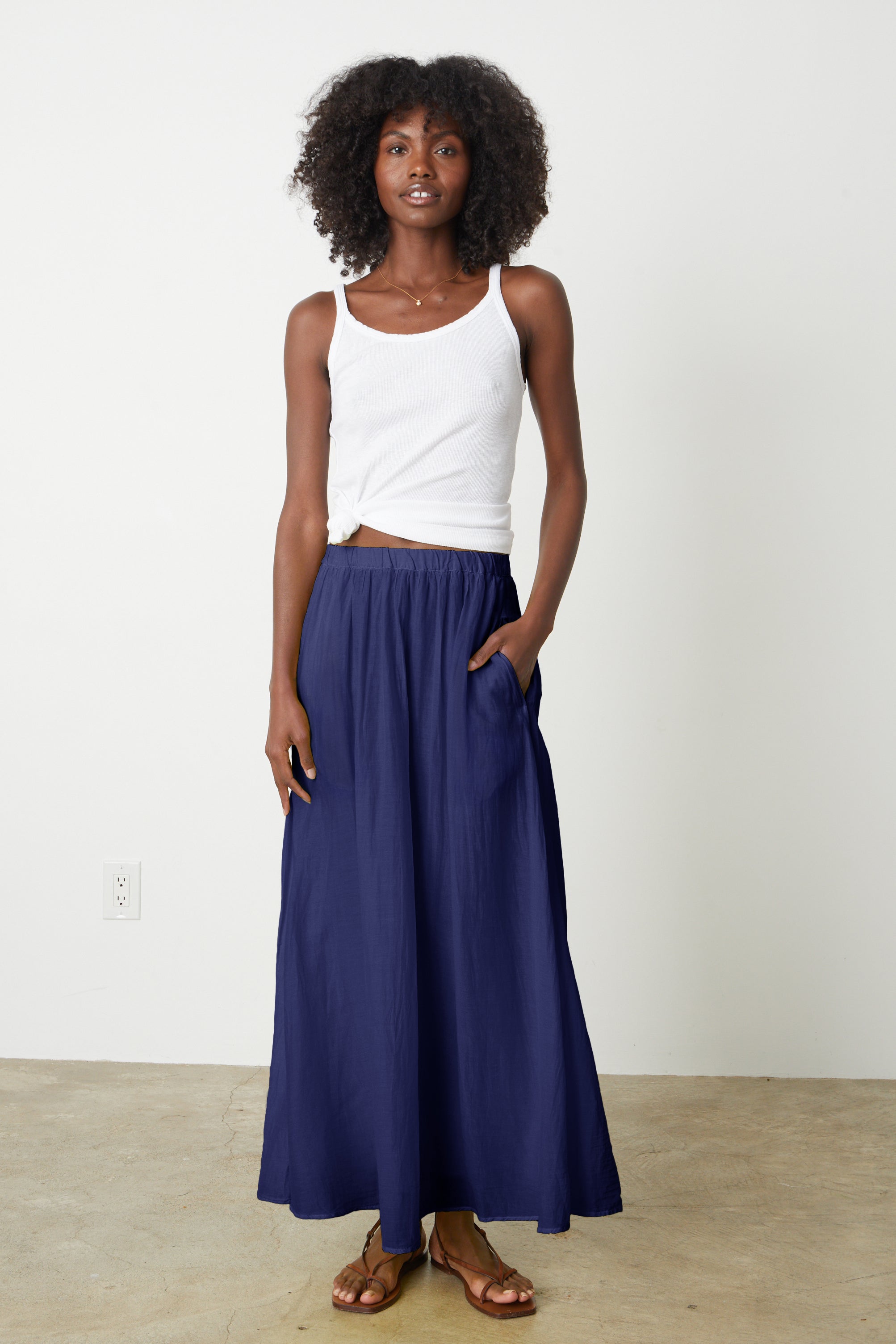The model is wearing the Velvet by Graham & Spencer MARIELA MAXI SKIRT.