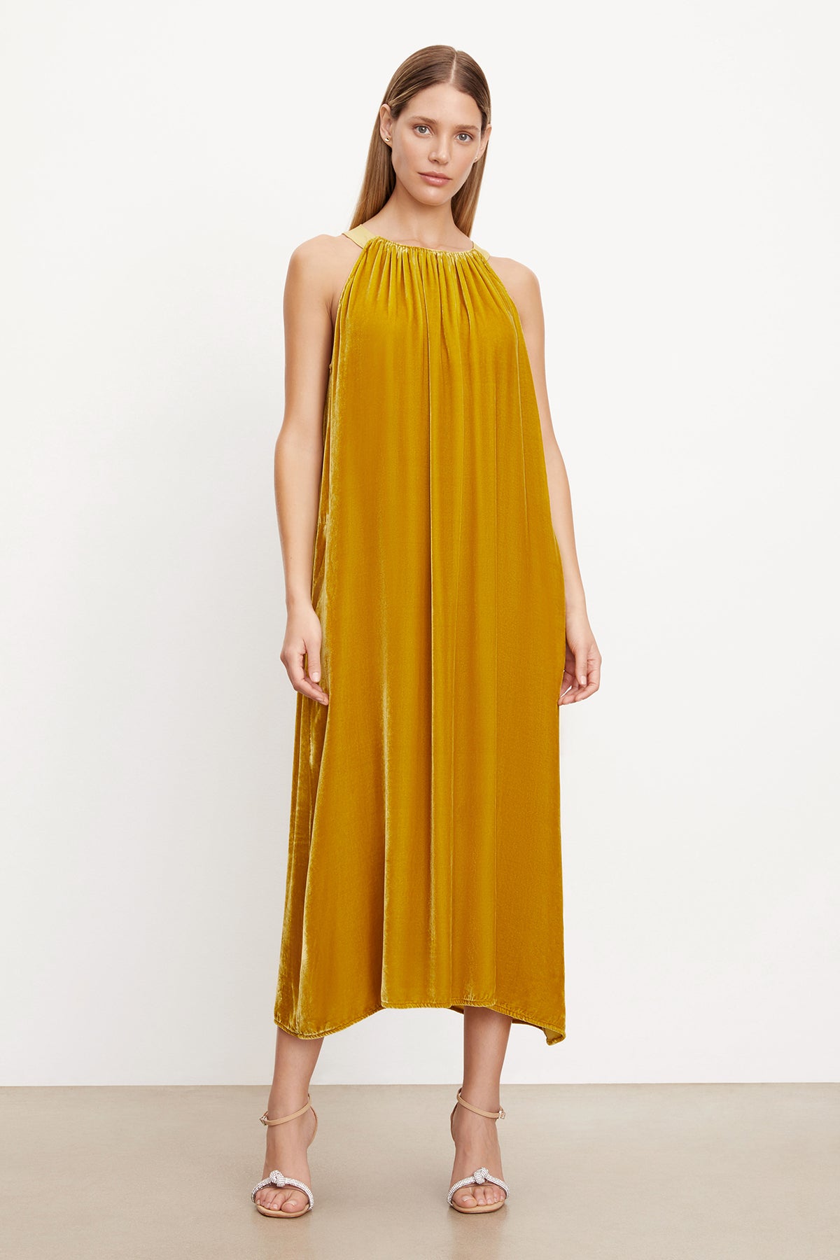A woman wearing a MAREN SILK VELVET HALTER DRESS by Velvet by Graham & Spencer.