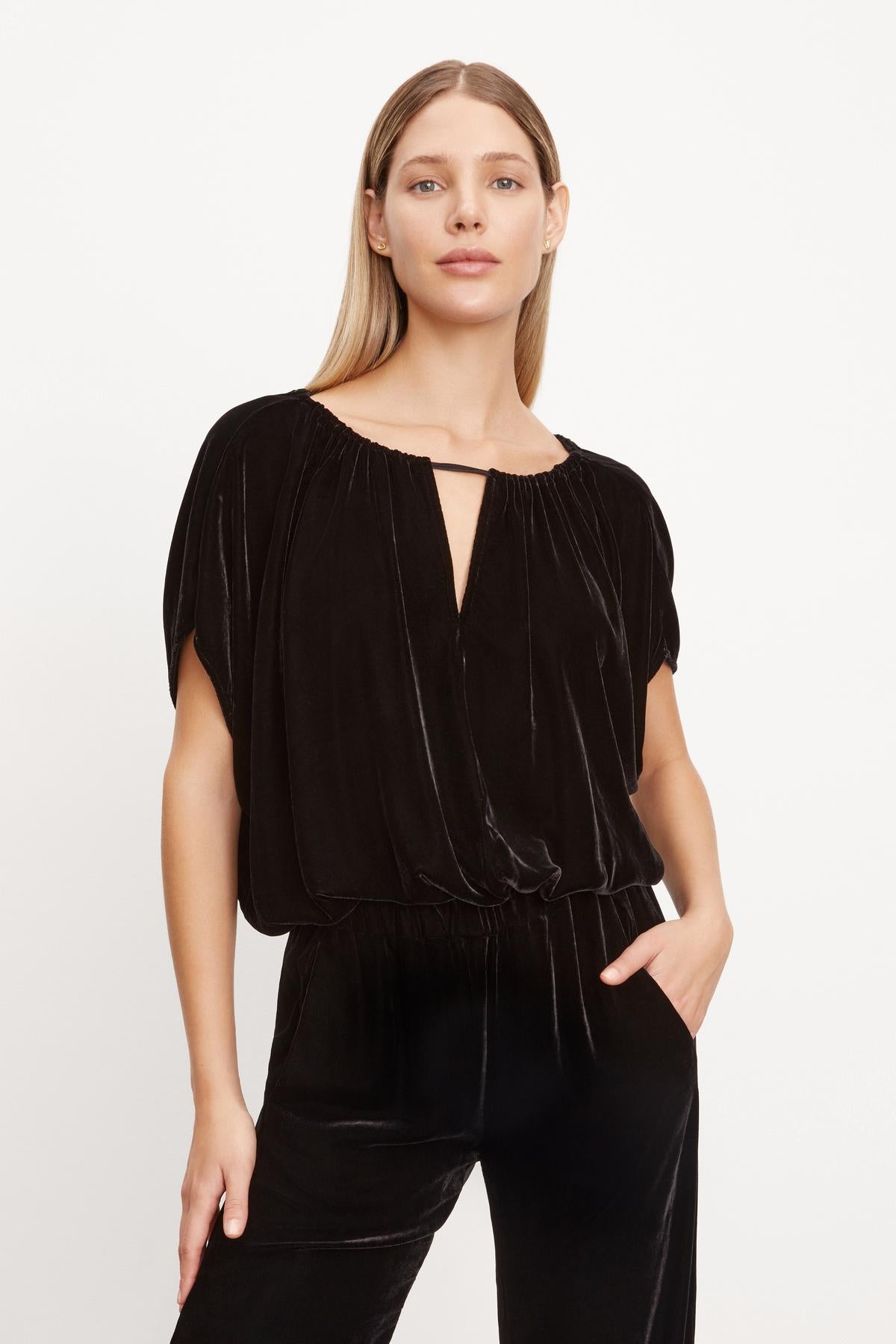 The Velvet by Graham & Spencer NOA SILK VELVET CROPPED TOP, made of silk velvet, is worn by a woman.-35654468763841