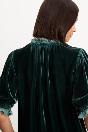 The back view of a woman wearing a VAL SILK VELVET TOP by Velvet by Graham & Spencer that exudes timeless elegance.