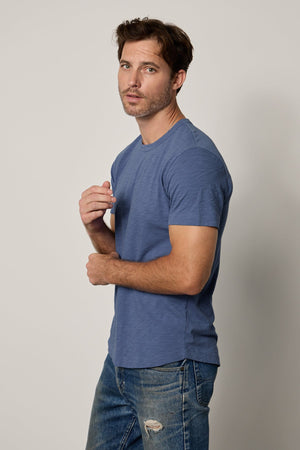 a man wearing a Velvet by Graham & Spencer AMARO CREW NECK SLUB TEE and jeans.