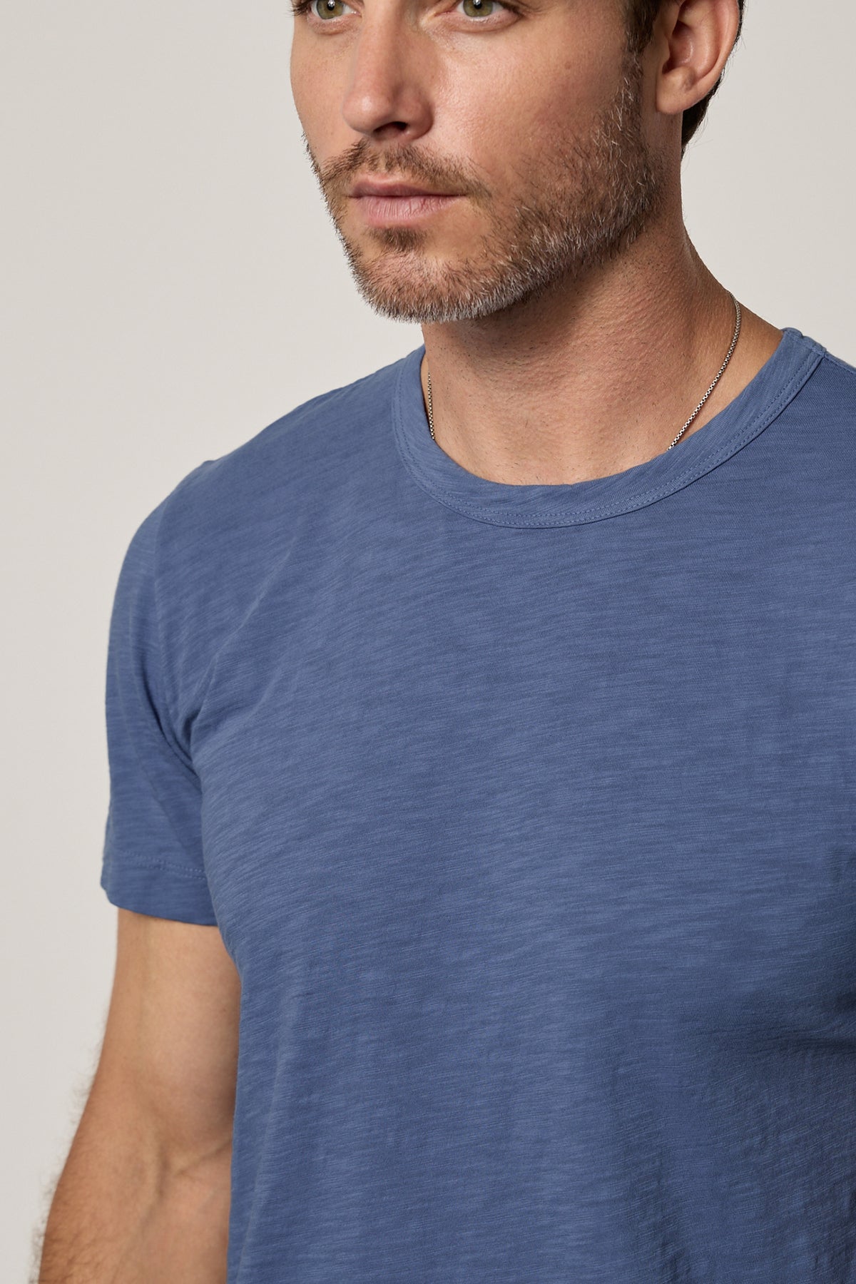 a man wearing a Velvet by Graham & Spencer AMARO CREW NECK SLUB TEE.