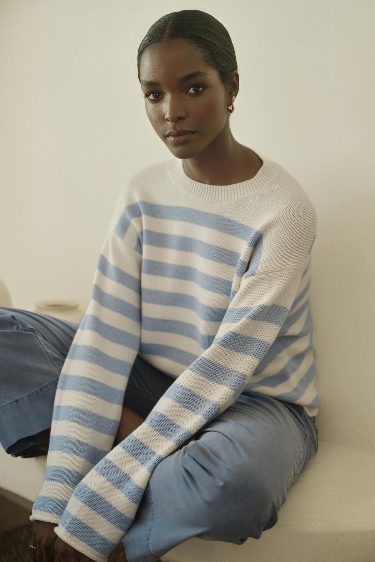 A woman wearing a blue and white striped sweater paired with MYA COTTON CANVAS PANTS by Velvet by Graham & Spencer.