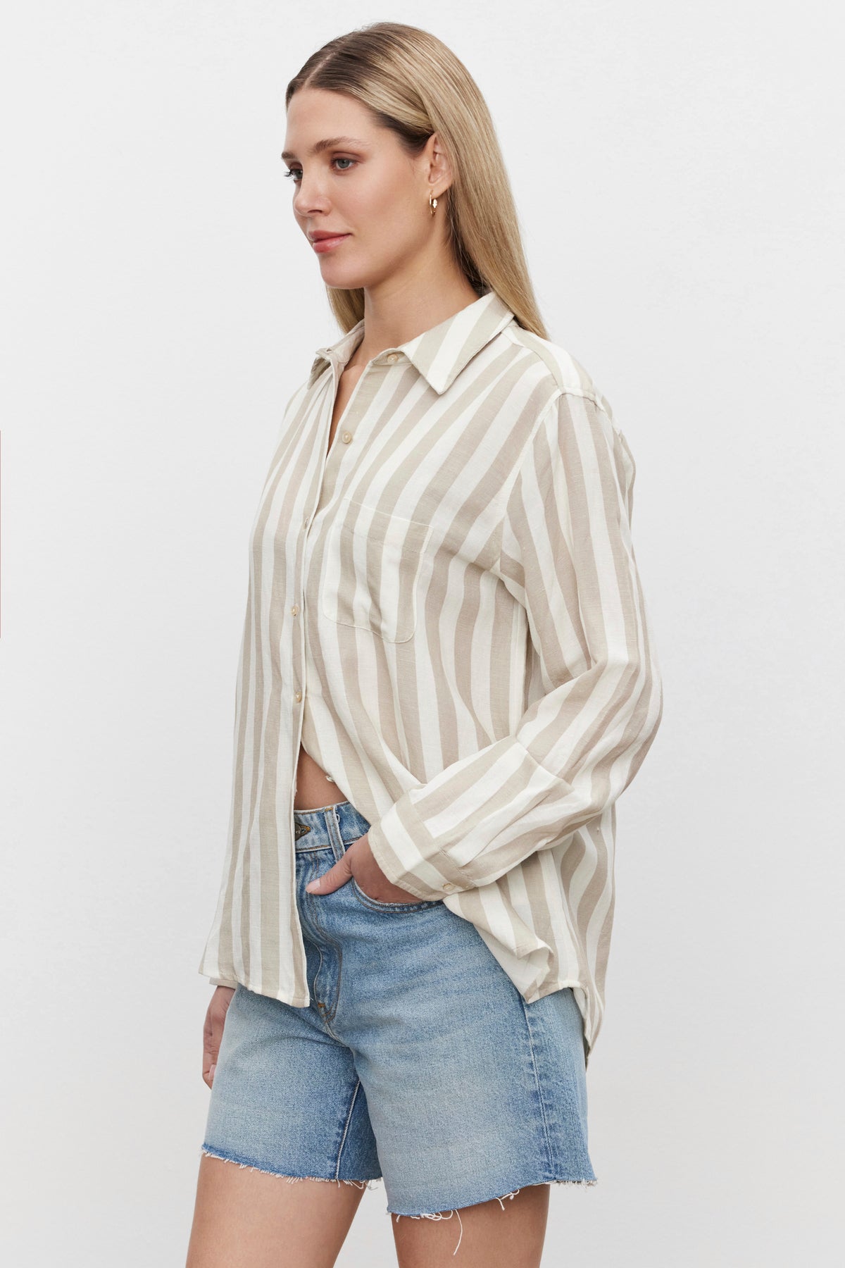 The model is wearing striped shorts and a Velvet by Graham & Spencer HARLOW STRIPED LINEN BUTTON-UP SHIRT.-36247888068801