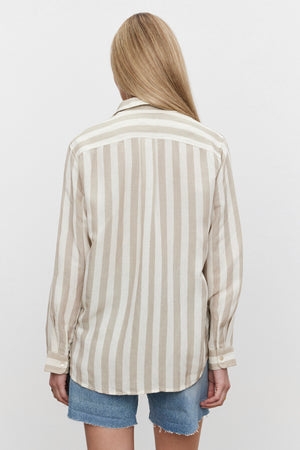 A woman wearing a Velvet by Graham & Spencer HARLOW STRIPED LINEN BUTTON-UP SHIRT in a relaxed fit, shown from the back.