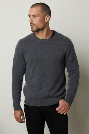 A man's DASHELL CREW NECK SWEATER by Velvet by Graham & Spencer, style, and warmth are evident as he wears a grey sweater.