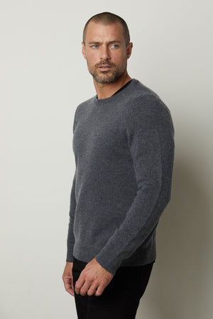 A man wearing a Velvet by Graham & Spencer DASHELL CREW NECK SWEATER exudes warmth and style.
