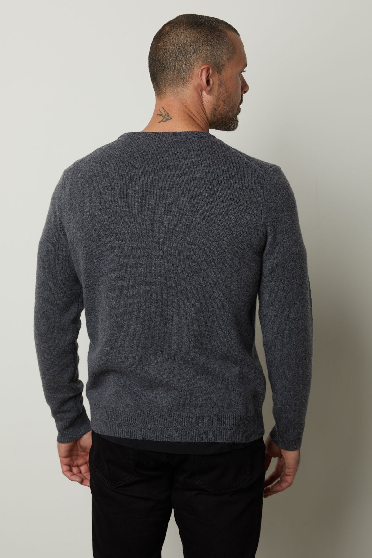 The back view of a man wearing a cozy Velvet by Graham & Spencer DASHELL CREW NECK SWEATER exudes style and warmth.-35606055878849