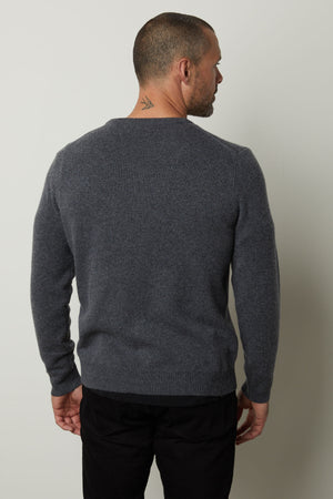The back view of a man wearing a cozy Velvet by Graham & Spencer DASHELL CREW NECK SWEATER exudes style and warmth.
