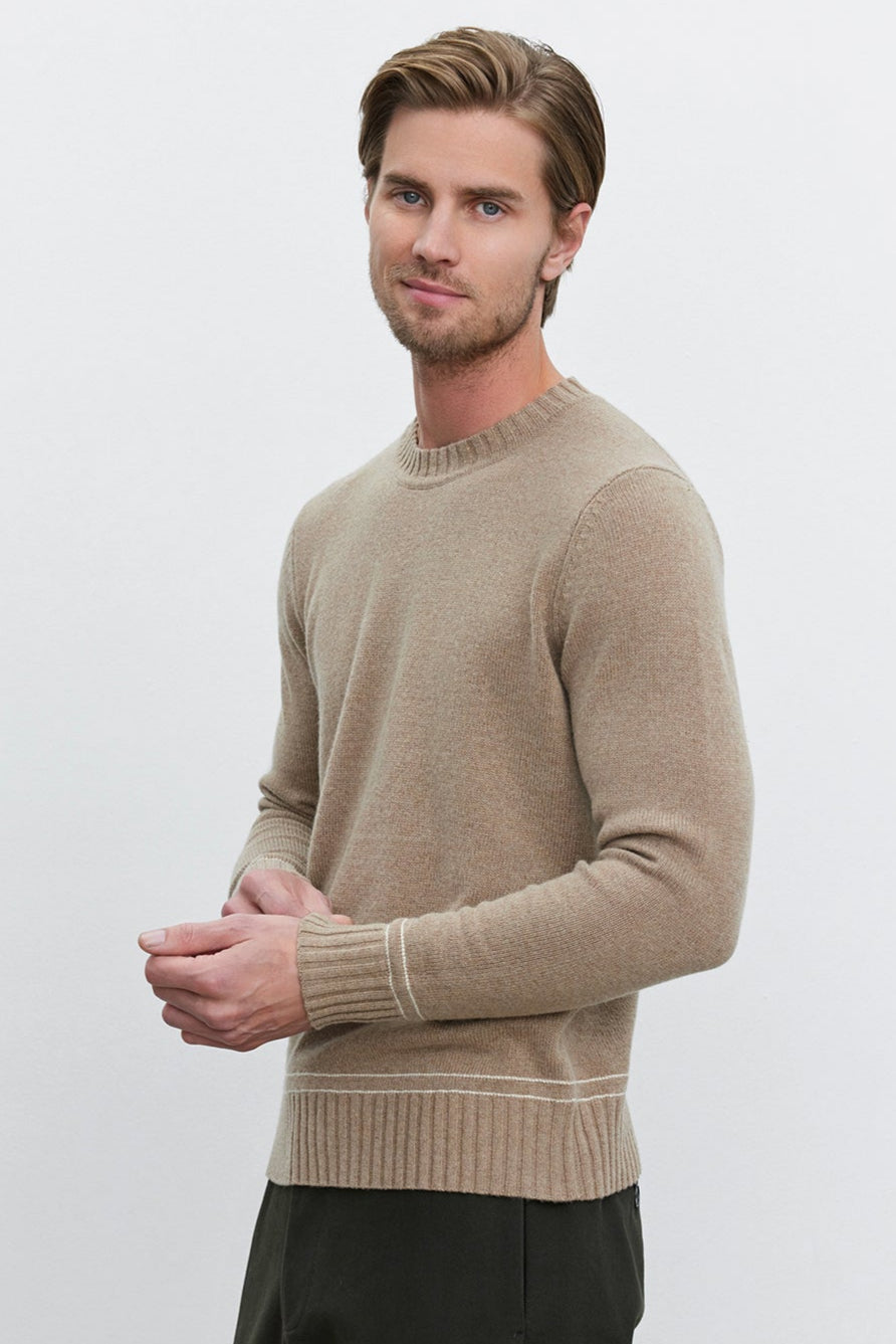 A man with light brown hair stands against a plain background wearing the ATTICUS SWEATER by Velvet by Graham & Spencer and dark green pants.-37893828346049