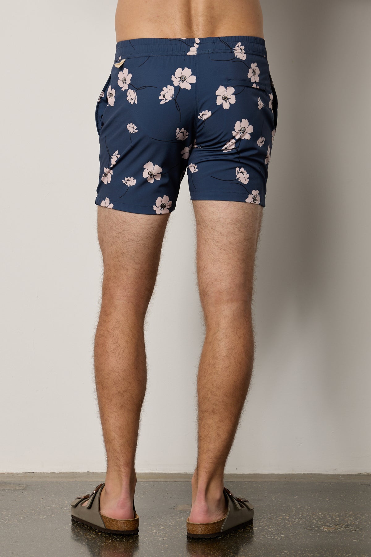 the back view of a man wearing Velvet by Graham & Spencer's RICARDO PRINTED SWIM SHORT.-26471685226689