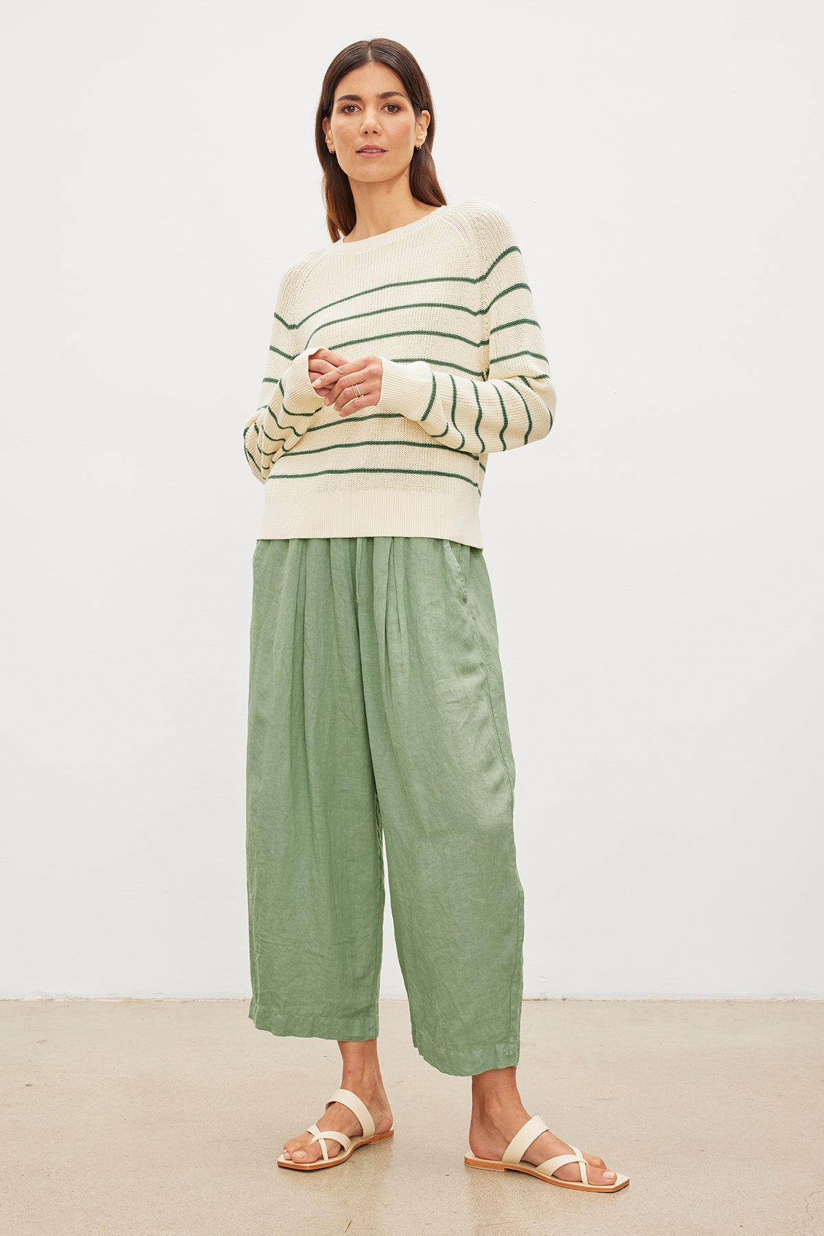 The model is wearing a CHAYSE STRIPED CREW NECK SWEATER by Velvet by Graham & Spencer in a relaxed silhouette and textured cotton culottes.