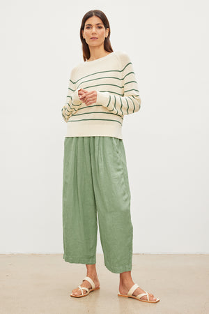 The model is wearing a CHAYSE STRIPED CREW NECK SWEATER by Velvet by Graham & Spencer in a relaxed silhouette and textured cotton culottes.