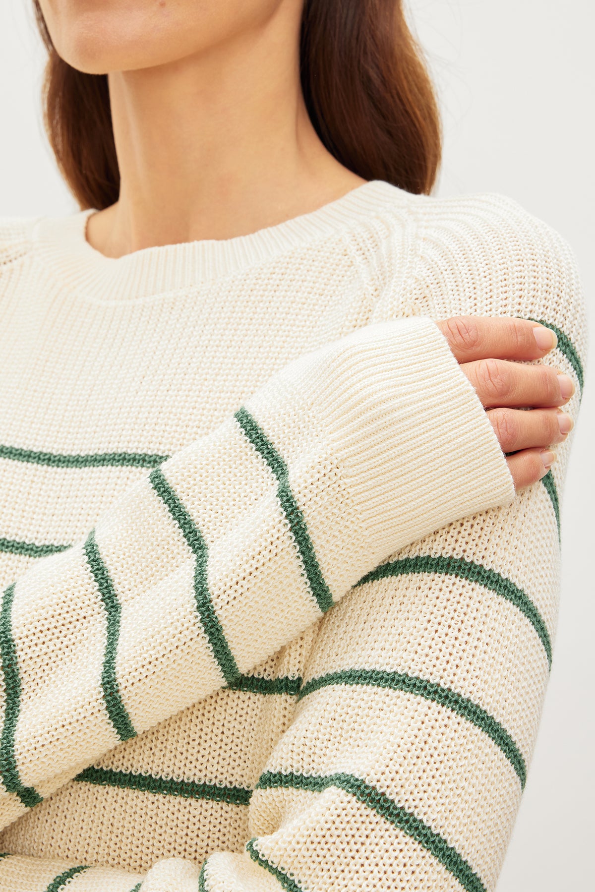 A woman wearing a CHAYSE STRIPED CREW NECK SWEATER made by Velvet by Graham & Spencer, featuring white and green stripes.-35955537051841