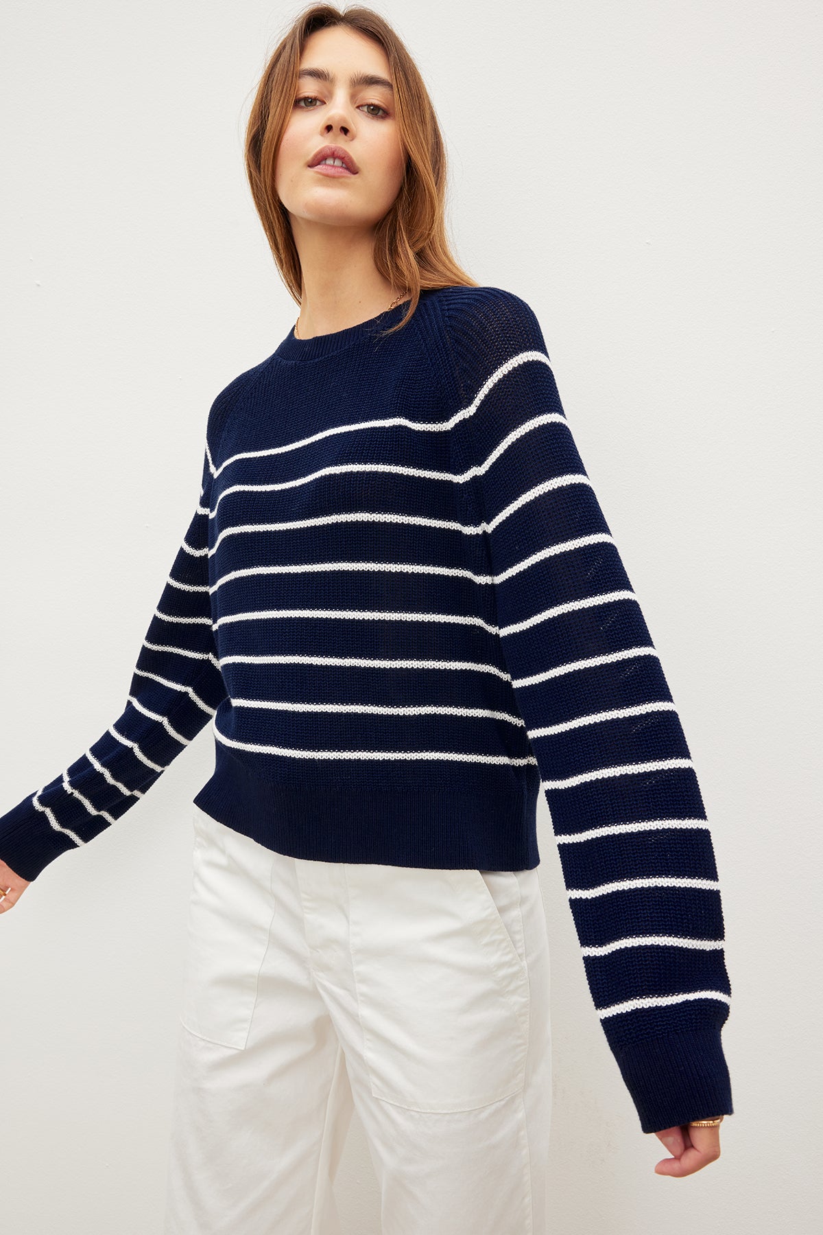 The model is wearing a Velvet by Graham & Spencer CHAYSE STRIPED CREW NECK SWEATER.