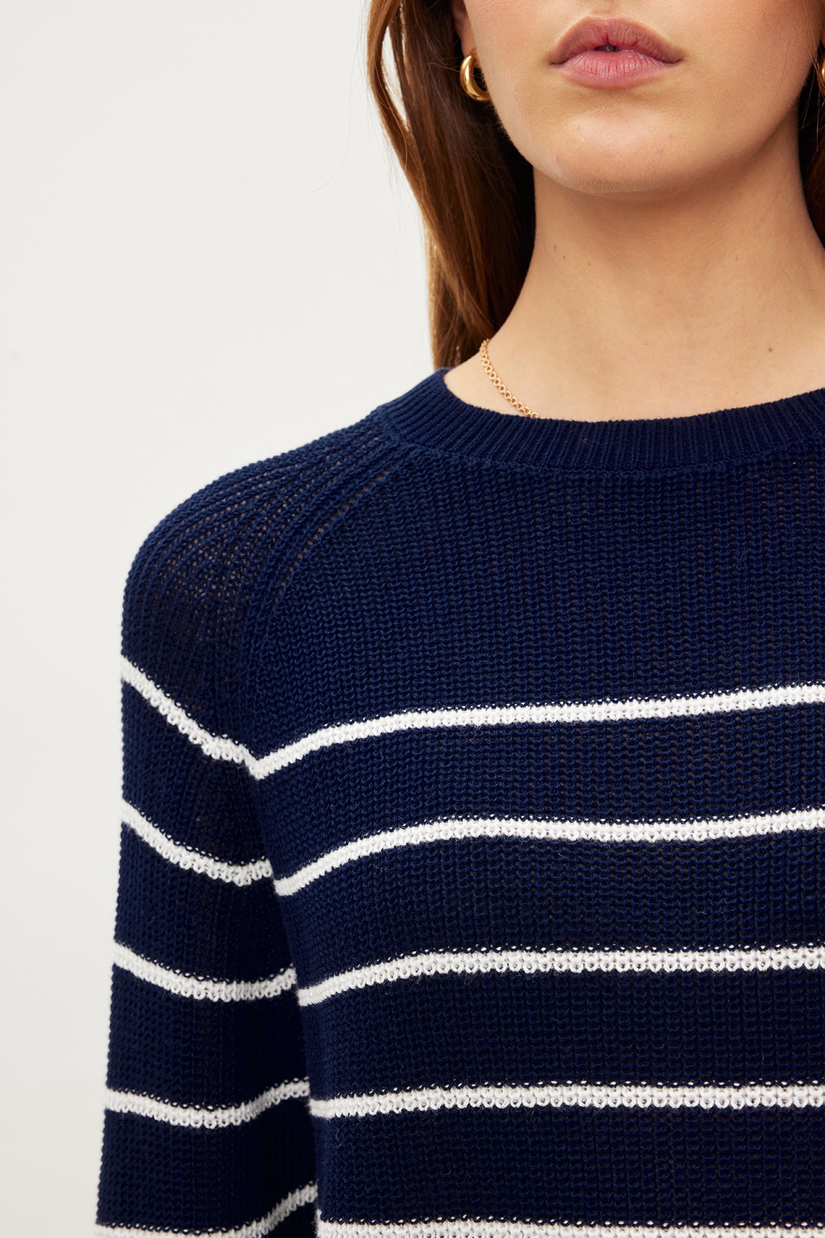The model is wearing a Velvet by Graham & Spencer CHAYSE STRIPED CREW NECK SWEATER with a relaxed silhouette.-35955537313985