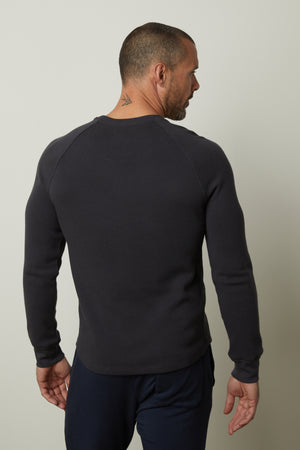 The man wearing a grey sweatshirt has a comfortable fit with the Velvet by Graham & Spencer GLEN THERMAL CREW.