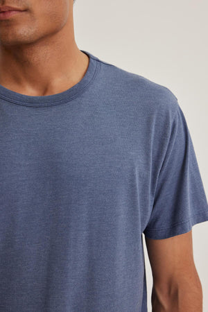Someone wearing the ZANDER TEE by Velvet by Graham & Spencer, partially visible against a neutral background.