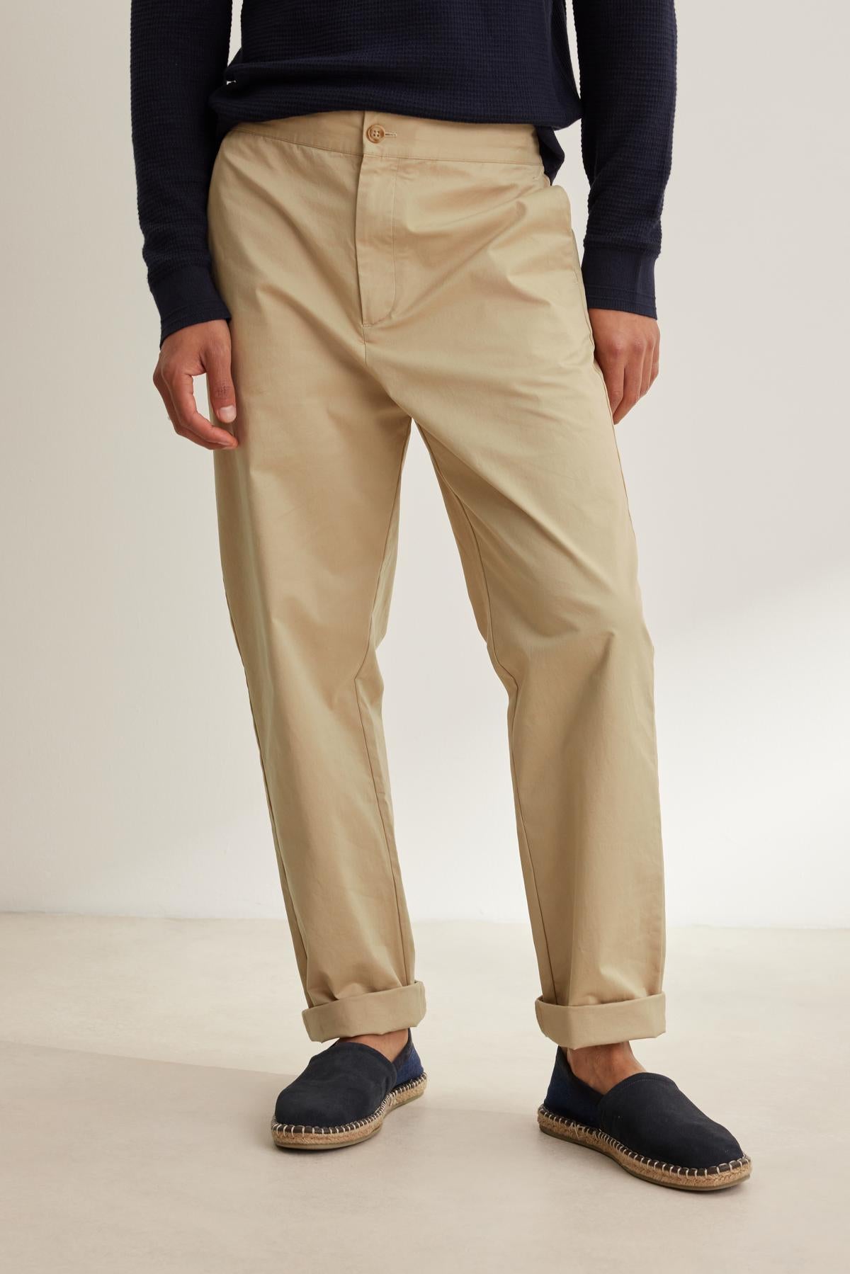 A person wears Velvet by Graham & Spencer's STONE PANT, a dark long-sleeve shirt, and black espadrilles, standing against a neutral background.-38643359514817