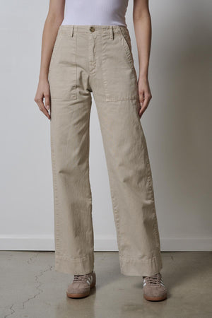 A woman wearing Velvet by Jenny Graham's VENTURA PANT in beige and a white top.